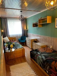 a bedroom with two beds and a desk and a chair at Rózsa nyaralóház in Balatonboglár