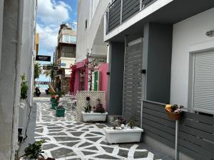 an alley with potted plants on the side of a building at Lefteris Apartment in Kardamaina