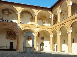 a large building with arches and paintings on the walls at Locazione Turistica LBS, San Giacomo , Spoleto in San Giacomo