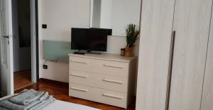 a tv on top of a dresser in a bedroom at La casa di Gergy in Borgomanero