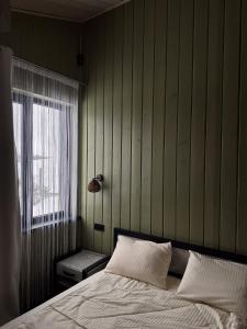 a bedroom with a bed and a window at Гимба in Podobovets