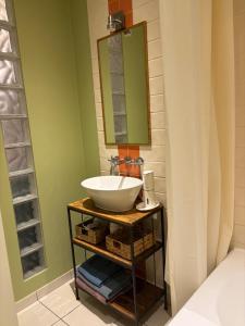 a bathroom with a sink and a mirror at Jurmala Cozy Vibes - self check in in Jūrmala +10 photos