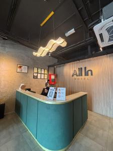 a lobby with a counter with a person sitting at it at ALL IN HOTEL in Kangar