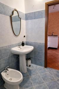 a bathroom with a sink and a toilet at Casa Giovio - Romantico appartamento di montagna in Blessagno