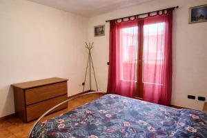 a bedroom with a bed and a dresser and a window at Casa Giovio - Romantico appartamento di montagna in Blessagno