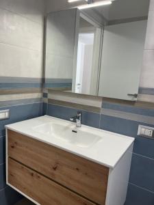 a bathroom with a sink and a mirror at Alysia House in Naples
