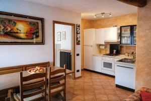 a kitchen with a table and a dining room at Casa Giovio - Romantico appartamento di montagna in Blessagno