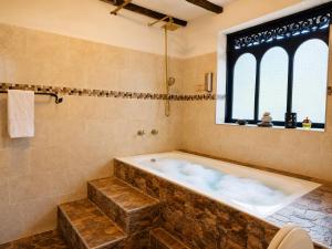 a large bathroom with a tub and a window at Hotel Pueblo Dorado Sesquilé in Sesquilé +49 photos