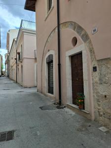 a building with a door on the side of a street at Dimora Tre Marie in LʼAquila