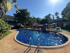a large swimming pool with a hose around it at Blue Privacy Resort in Nathon Bay +24 photos