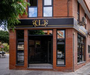 a store front of a brick building with a sign on it at Casa Luxore in Alicante