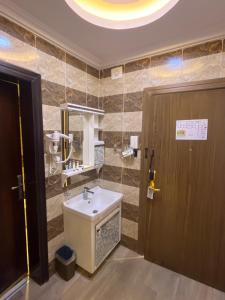 a bathroom with a sink and a mirror at Address Sharurah Hotel in Sharurah