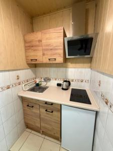 a small kitchen with a sink and a microwave at ApartmentsByMatyrafa-XVI in Tarnowskie Góry