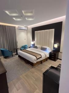 a hotel room with a bed and a television at Address Sharurah Hotel in Sharurah