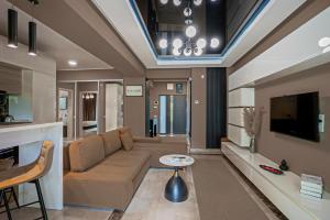 a living room with a couch and a tv at Sas 1 Luxury Apartments in Mamaia
