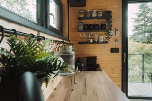 a kitchen with a table and chairs in a house at Chalúpka na kopcu in Buchlovice +14 photos