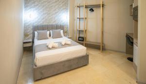 a bedroom with a bed with white sheets and pillows at Casa Luxore in Alicante