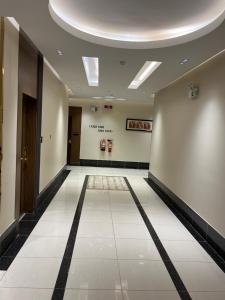 a hallway of a building with a tile floor at Address Sharurah Hotel in Sharurah