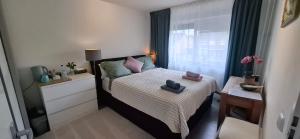 a small bedroom with a bed and a window at Homestay Maashees in Maashees