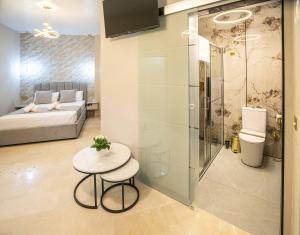 a room with a bed and a table with a stool at Casa Luxore in Alicante +23 photos