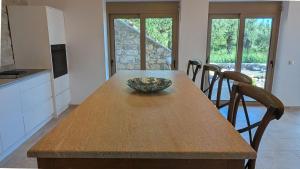 a kitchen with a wooden table with a bowl on it at Achilles Cottage in Kardamyli