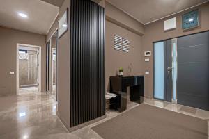 a hallway of a home with a shower and a desk at Sas 1 Luxury Apartments in Mamaia +22 photos