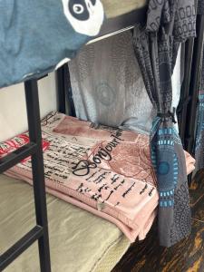 a bunk bed with a pillow and a blanket at Manavi Hostel Near by Mathura Railway Station in Mathura