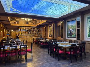 a dining room with tables and chairs and a skylight at Plaža in Varvarin