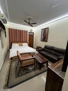 a living room with a bed and a couch at Vedic Dham Ganga in Rishīkesh