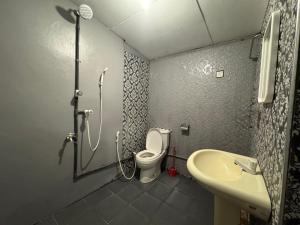 a bathroom with a shower and a toilet and a sink at Moonlight surf hostel in Arugam Bay