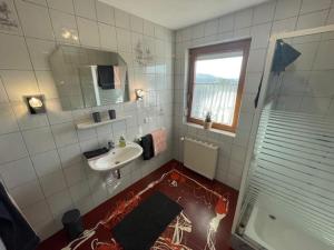 a bathroom with a sink and a mirror at Ferienwohnung Silvia in Sankt Kanzian +98 photos