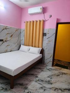 a bedroom with a bed and a air conditioner on the wall at G3 house Pondicherry in Pondicherry +5 photos