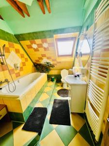 a bathroom with a tub and a toilet and a sink at Penzión Tyché in Šurany +201 photos