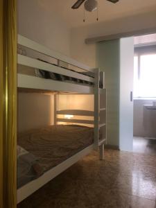 a bunk bed in a room with a ceiling fan at Mediterranean Apartment with WIFI in Canet de Berenguer