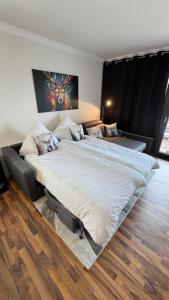 a large bed in a room with wooden floors at Teufelsberg Panorama mit Sauna und Bergblick in Langelsheim