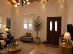 a living room with a couch and a table at Casa Ortensia in Kato Korakiana