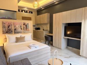 a bedroom with a large white bed and a tv at Ya Bayté in Beirut