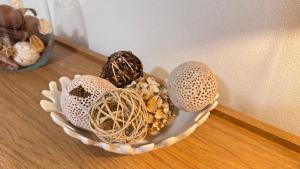 a bowl filled with different types of shells on a table at Villa Nueva Martinique in Gros-Morne