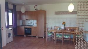eine Küche mit Tisch und Stühlen und eine Küche mit Waschmaschine in der Unterkunft Helly House in Isernia