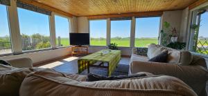 a living room with two couches and a television at 2 Bedroom Cottage With Spa Accommodations in Glemmingebro