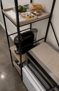 a shelf with a microwave and some food on it at Reale Guest House in Mascalucia