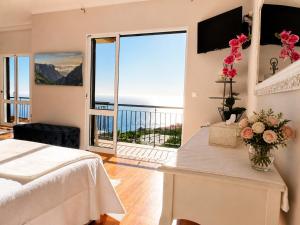 a bedroom with a bed and a view of the ocean at Bluegreen in Arco da Calheta