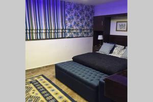 a bedroom with a bed and a couch in it at Royal Luxury Apartments & Studios 2 in Amman