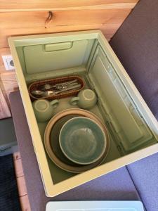 a box with a plate and utensils in it at Obstgarten im Warnetal- Campingfass Kobel in Gielde