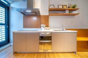a kitchen with a sink and a counter at Tainan Little Day in Tainan +68 photos