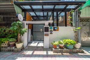 an entrance to a building with pots of plants at Tainan Little Day in Tainan