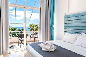 a bedroom with a bed and a view of the ocean at Saranda Hotel in Sarandë +264 photos