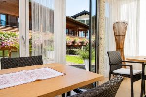 a dining room with a wooden table and chairs at Villa Egger in Lofer