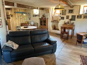 a living room with a couch and a table at Chambre 1 bord de rivière in Damvix