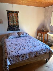 a bedroom with a bed with a tapestry on the wall at Chambre 1 bord de rivière in Damvix